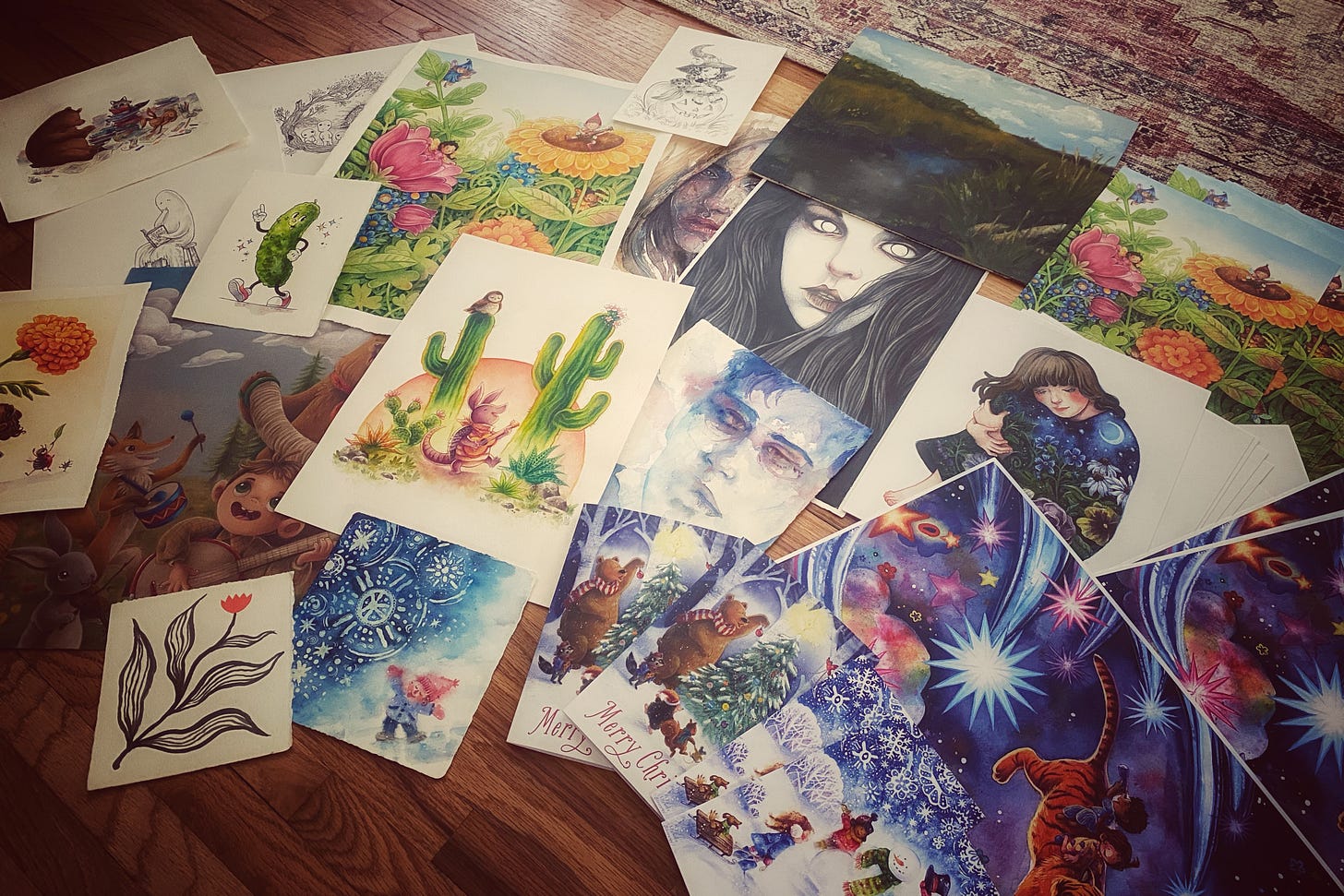 Photo of a variety of prints and original artwork, including children's illustrations and portraits.