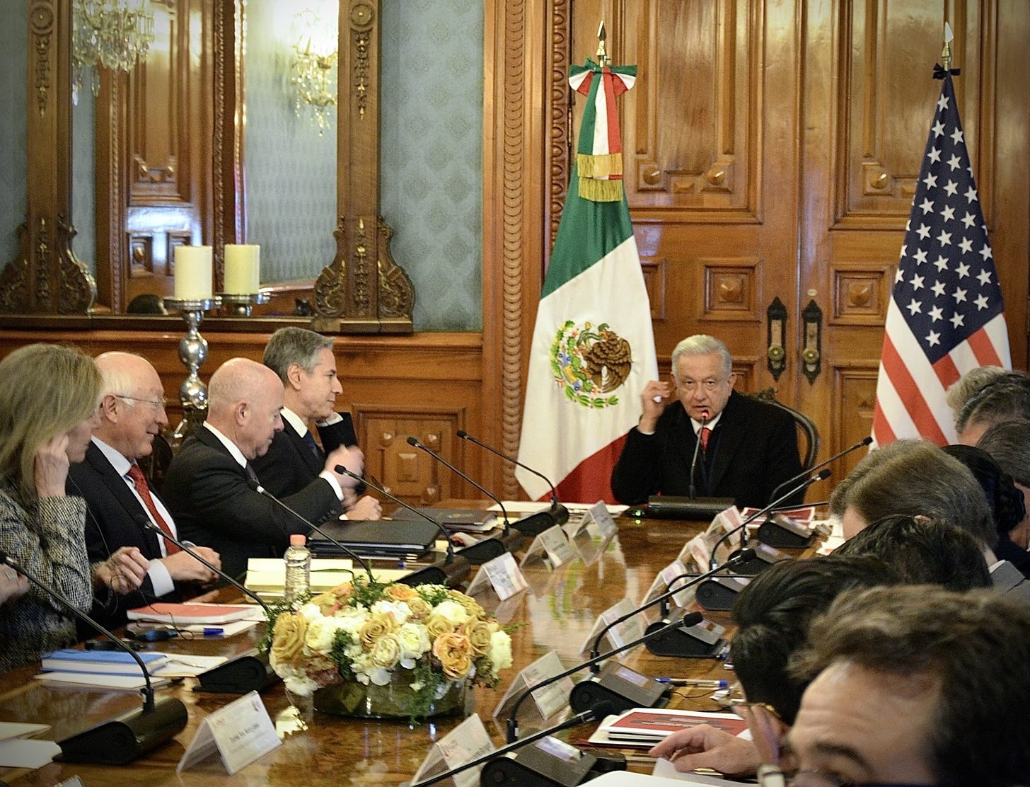 Secretary Blinken and other U.S. officials are sitting at a table with Mexican President Lopez Obrador and other Mexican officials. 