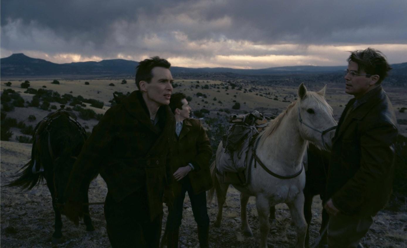 Still from the movie Oppenheimer, with horses and men on a plain