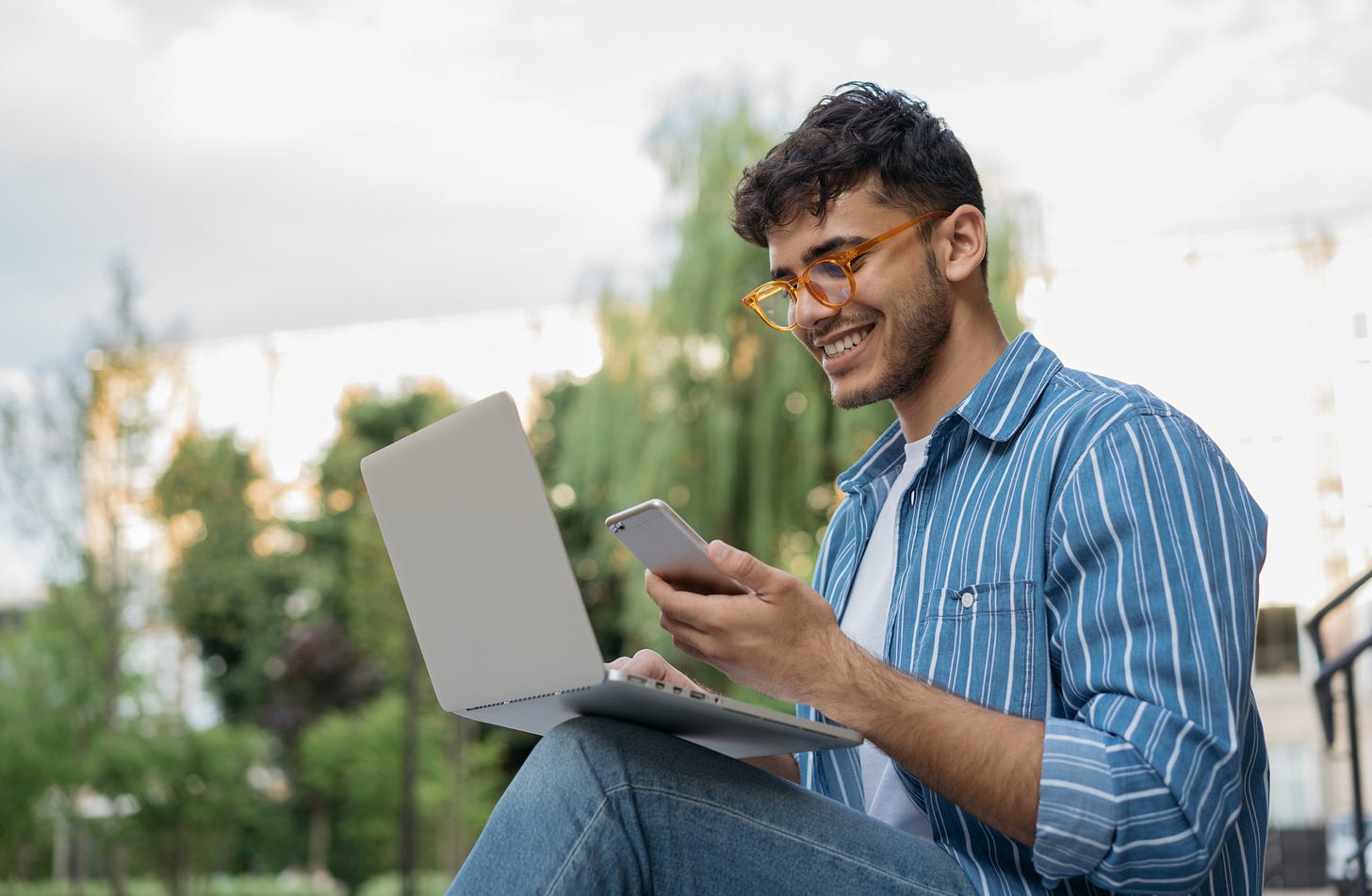 A young professional updates his profile on LinkedIn.