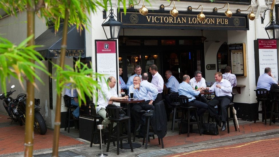 City workers drinking at a British style pub in Boat Quay, Singapore (Credit: Alamy)