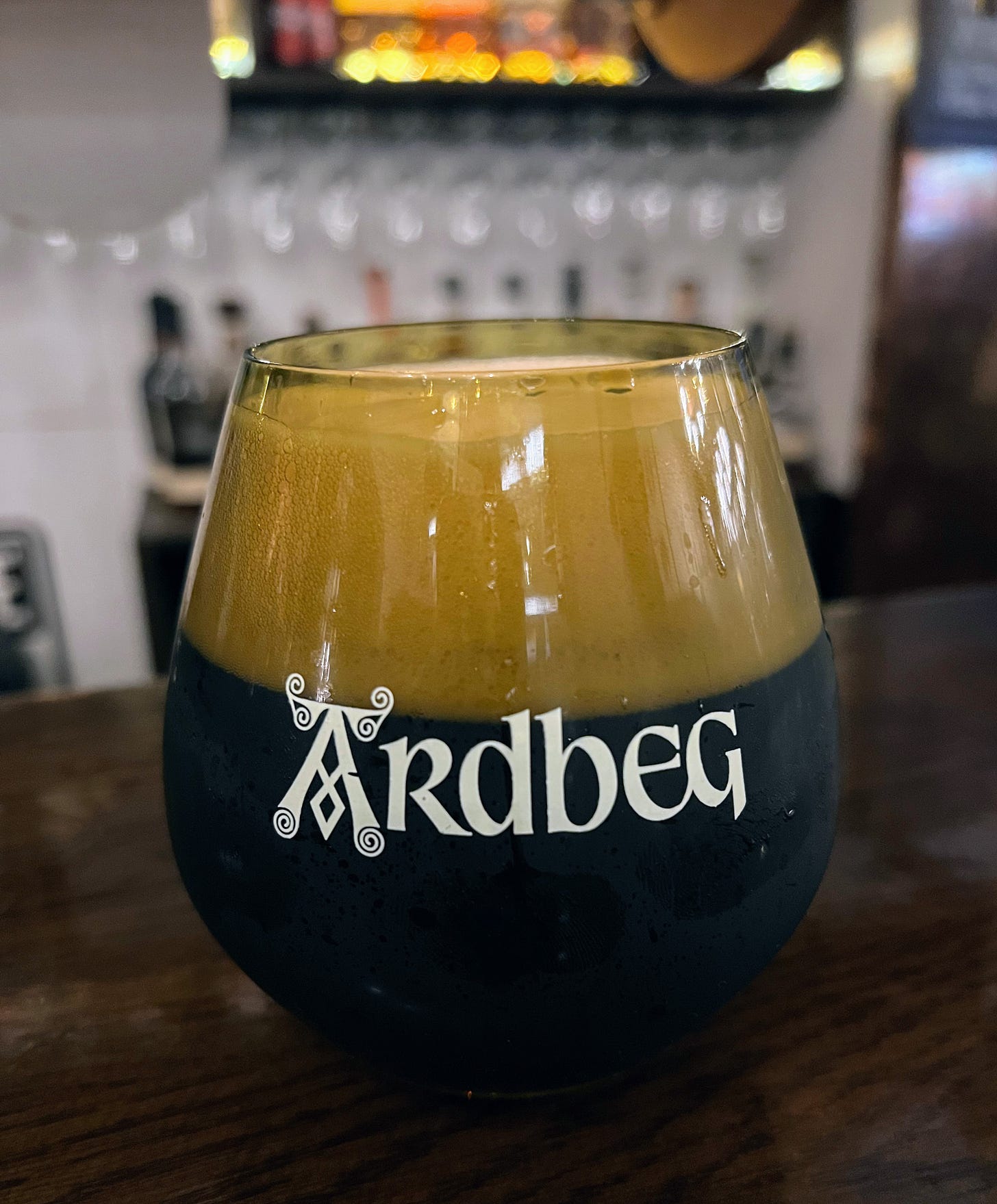 Glass of Ardbeg beer with a foamy head