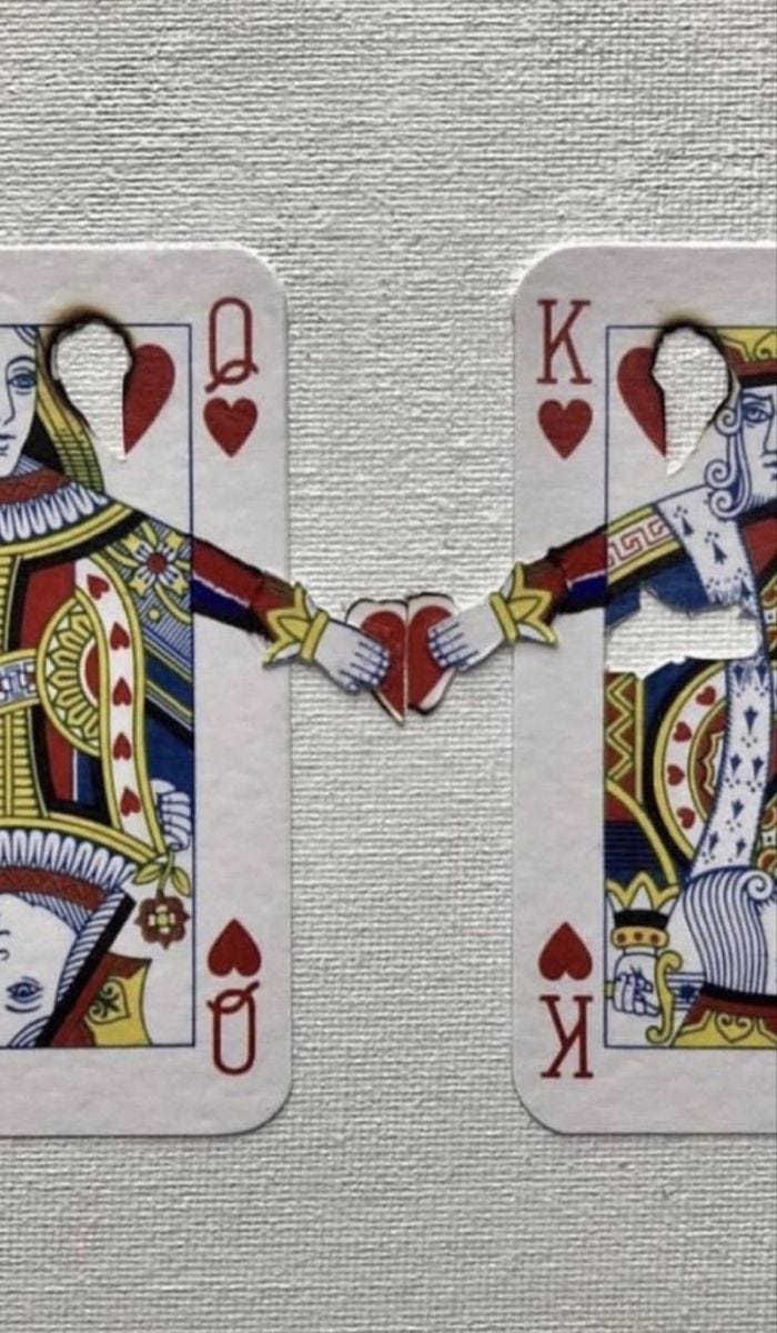 This may contain: two playing cards with the king and queen holding hands