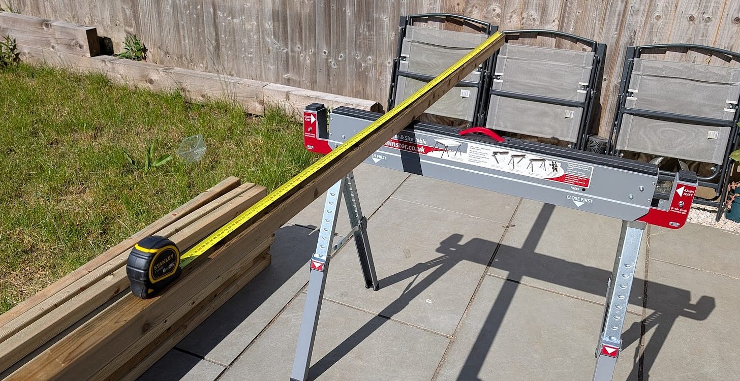 Using a tape measure to mark out the first pieces for the new shed project. 