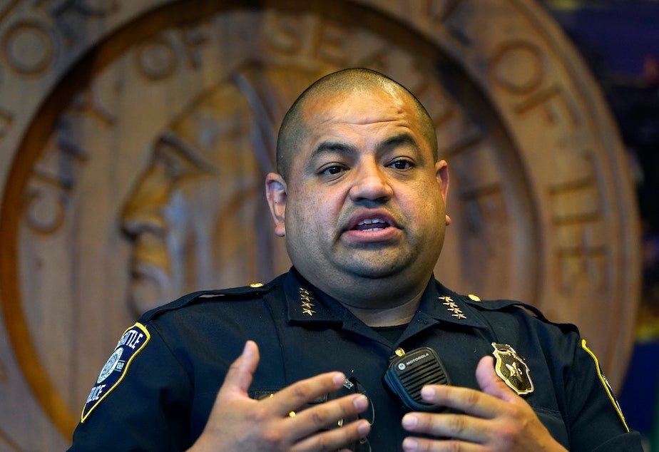 caption: Interim Seattle Police Chief Adrian Diaz addresses a news conference about changes being made at the department, earlier this month. The SPD announced Thursday that an officer seen on video rolling his bicycle over a downed protester was suspended pending an investigation.