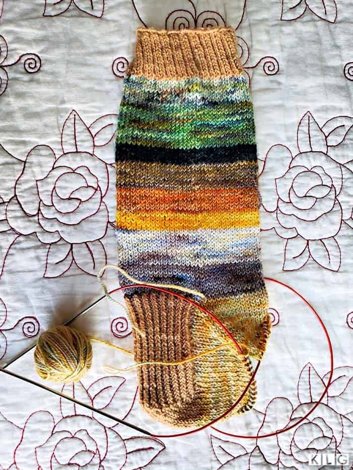 The gusset decreases complete on my striped socks in the pale green and yellow Koigu yarn