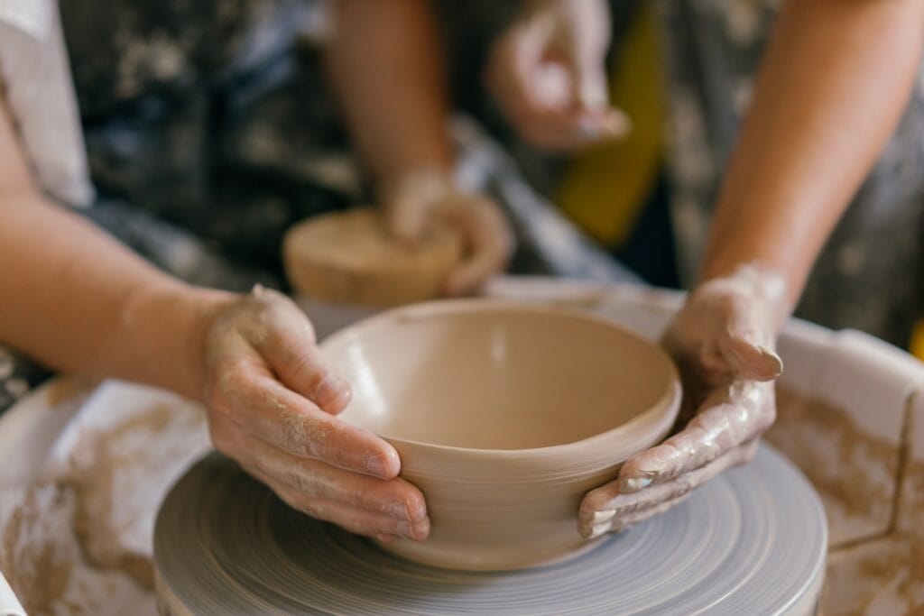 Moulding clay using hands