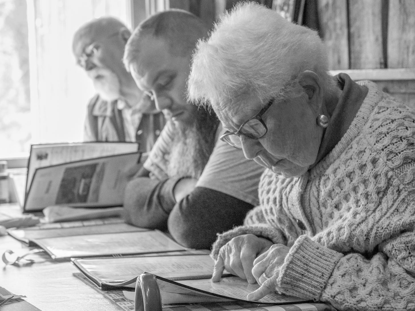 Three people studying a menu