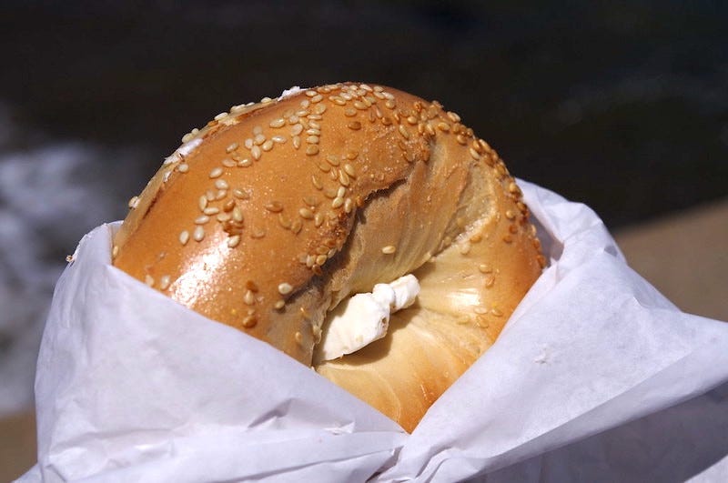 A sesame bagel with cream cheese