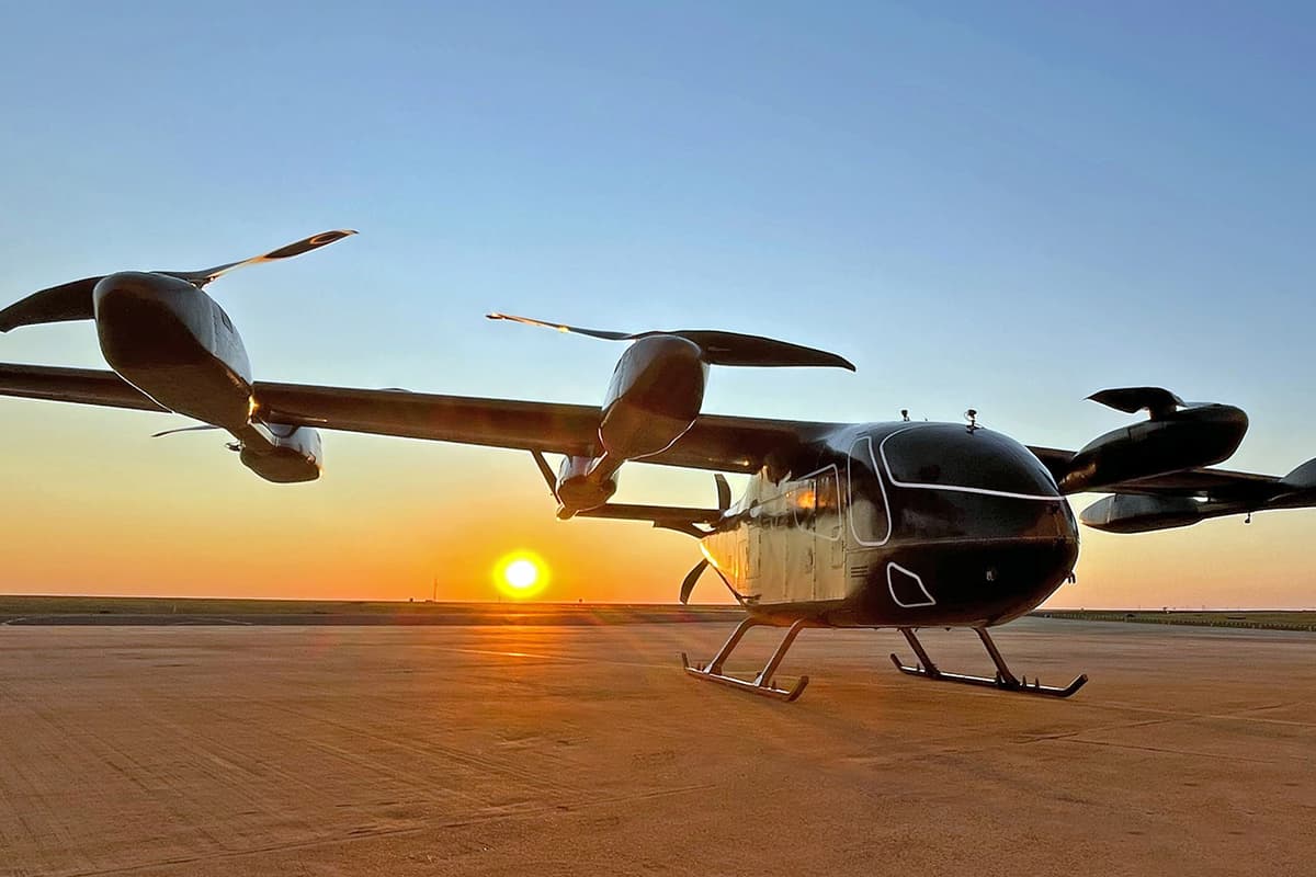 The prototype Eve Air Mobility sits magestically against the setting sun backdrop