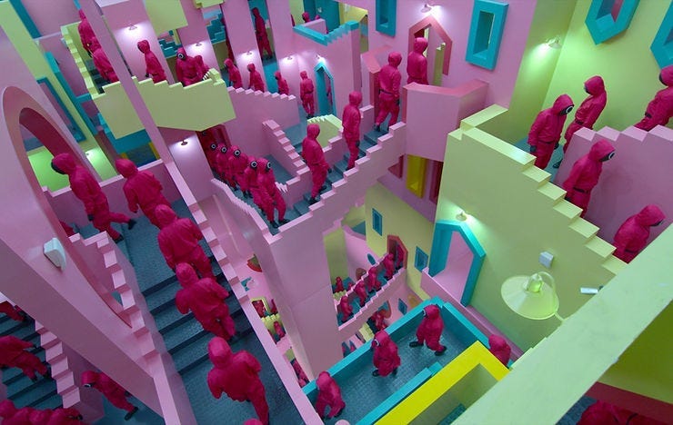 Characters in pink suits walk through a colorful, surreal staircase maze. Walls are pastel shades of pink, green, and yellow, creating an enigmatic mood.