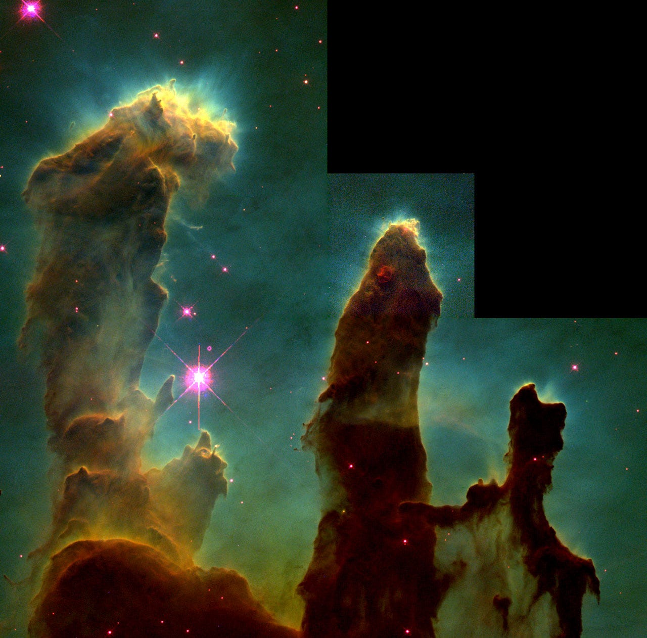 A series of orange-brown pillars of gas against a greenish-black cosmos, dotted here and there with red and pinkish galaxies. 