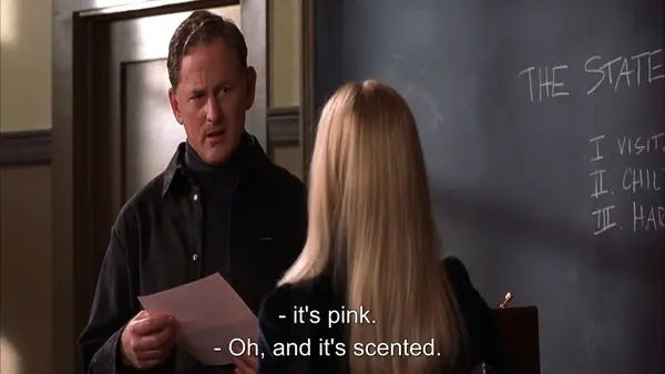 Elle Woods from Legally Blonde shows a professor her pink and scented application for a university place