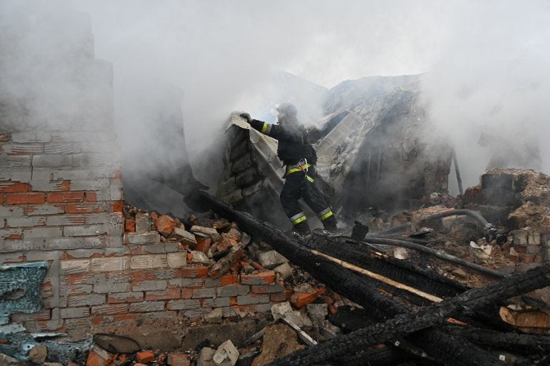 A rescuer of the State Emergency Service works to put out a fire