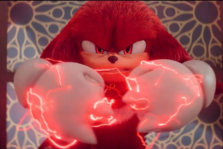A screenshot of Knuckles in the new Paramount+ series. He has an angry expression and is holding his fists in front of him, crackling with red electricity
