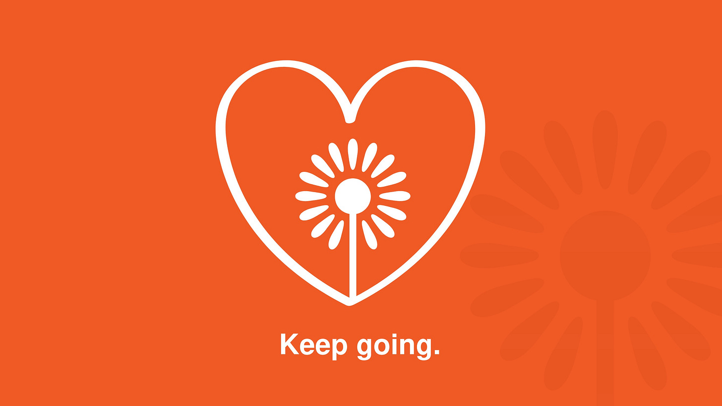 Orange background with white graphic of a flower inside of a heart and the words "Keep Going" below 