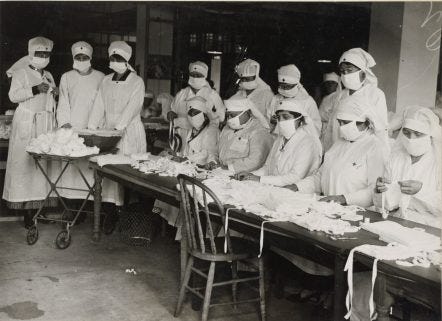 Red Cross nurses folding cloth masks (in 1918)