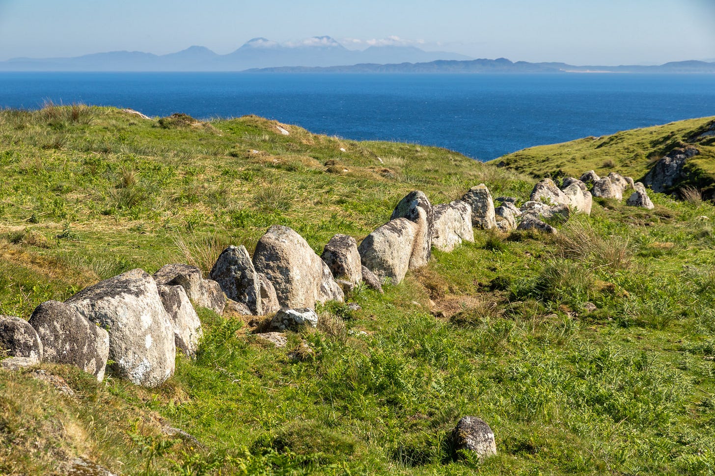 The remains of an ancient ‘dog tooth’ wall with the Paps of Jura on the skyline and lower Colonsay in front © Felicity Martin The remains of an ancient ‘dog tooth’ wall with the Paps of Jura on the skyline and lower Colonsay in front © Felicity Martin