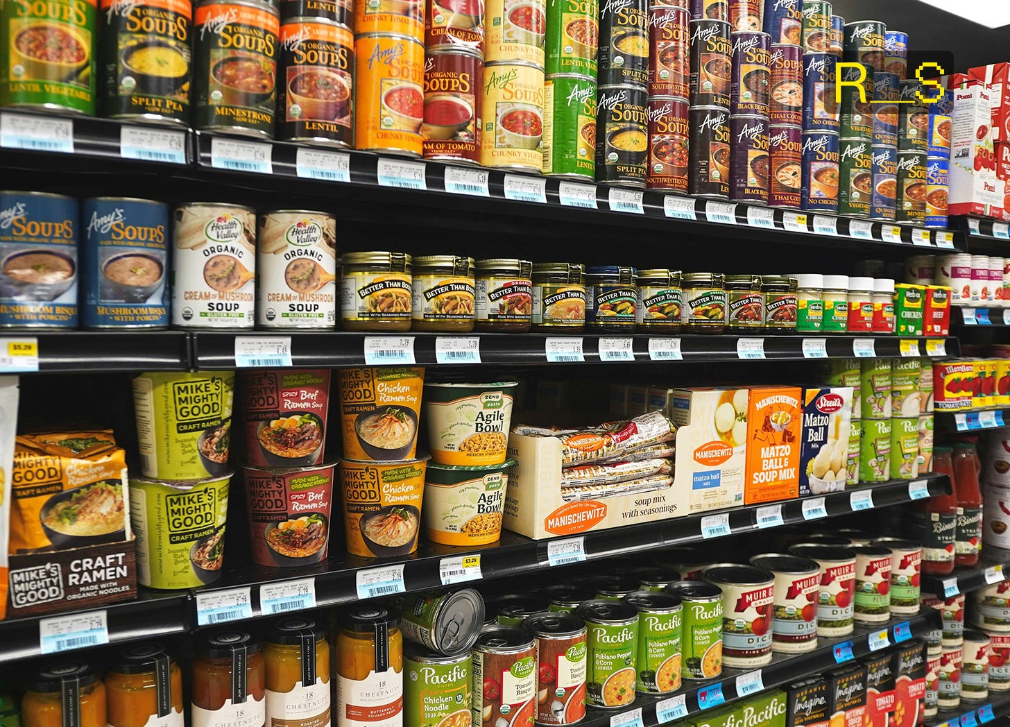 Neatly organized shelves, featuring rows of canned foods, jarred goods, and bulk dry staples stored on shelves for long-term emergency food preparedness.