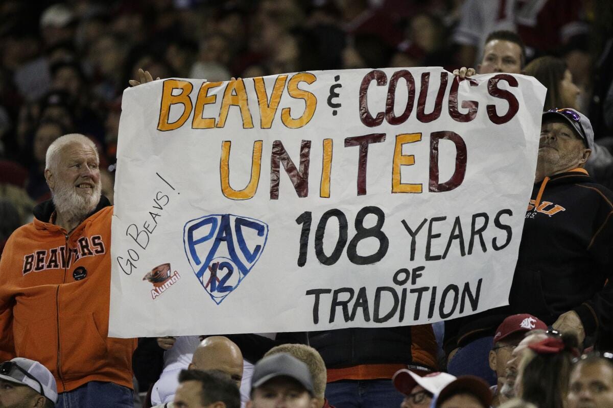 An Oregon State fans hold a "Pac-2" sign, representing the two schools that will remain in the Pac-12.