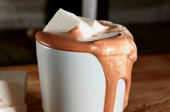 Overflowing hot chocolate with a marshmallow