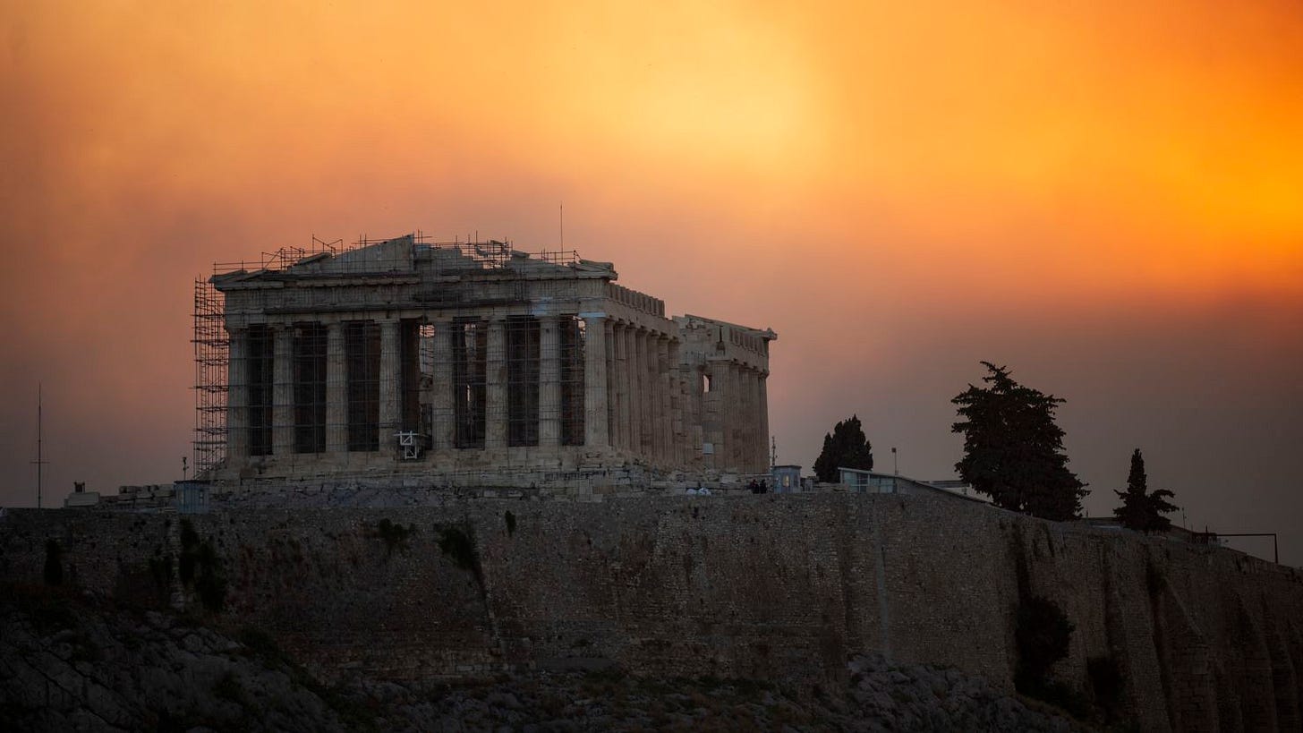 Fires rage in the hilltops behind the Parthenon temple in Athens, August 12, 2024.