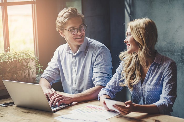 A man and woman working on a laptop. A man and woman working on a laptop.