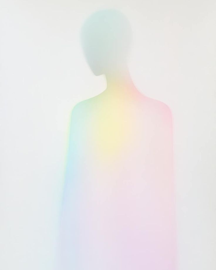 This may contain: the shadow of a person standing in front of a white wall with a multicolored background