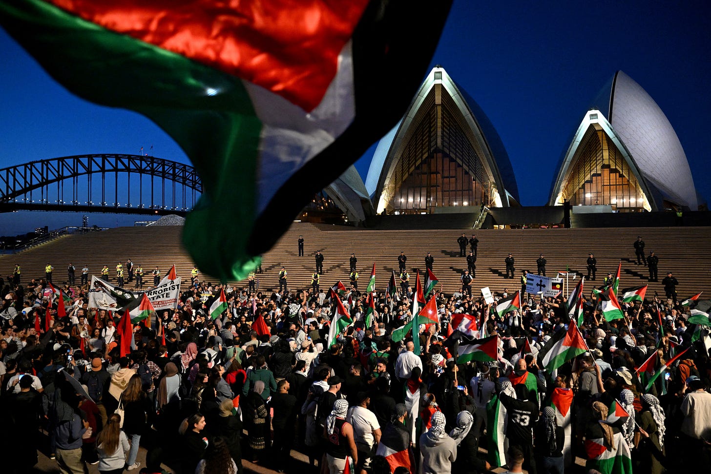 Participants of a pro-Palestinian rally react outside the Sydney Opera House in Sydney