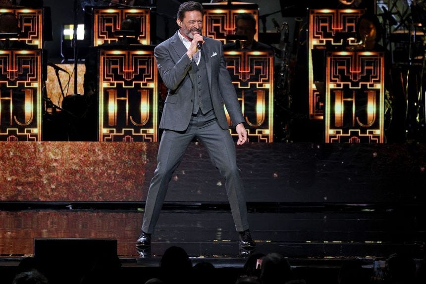 Image may contain Hugh Jackman Performer Person Solo Performance Adult Electrical Device Microphone and Clothing