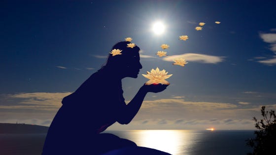 Moonlight dances on the surface of the water. Her silhouette sits on the rock, blooming golden lotuses from her lips and kissing them into the air