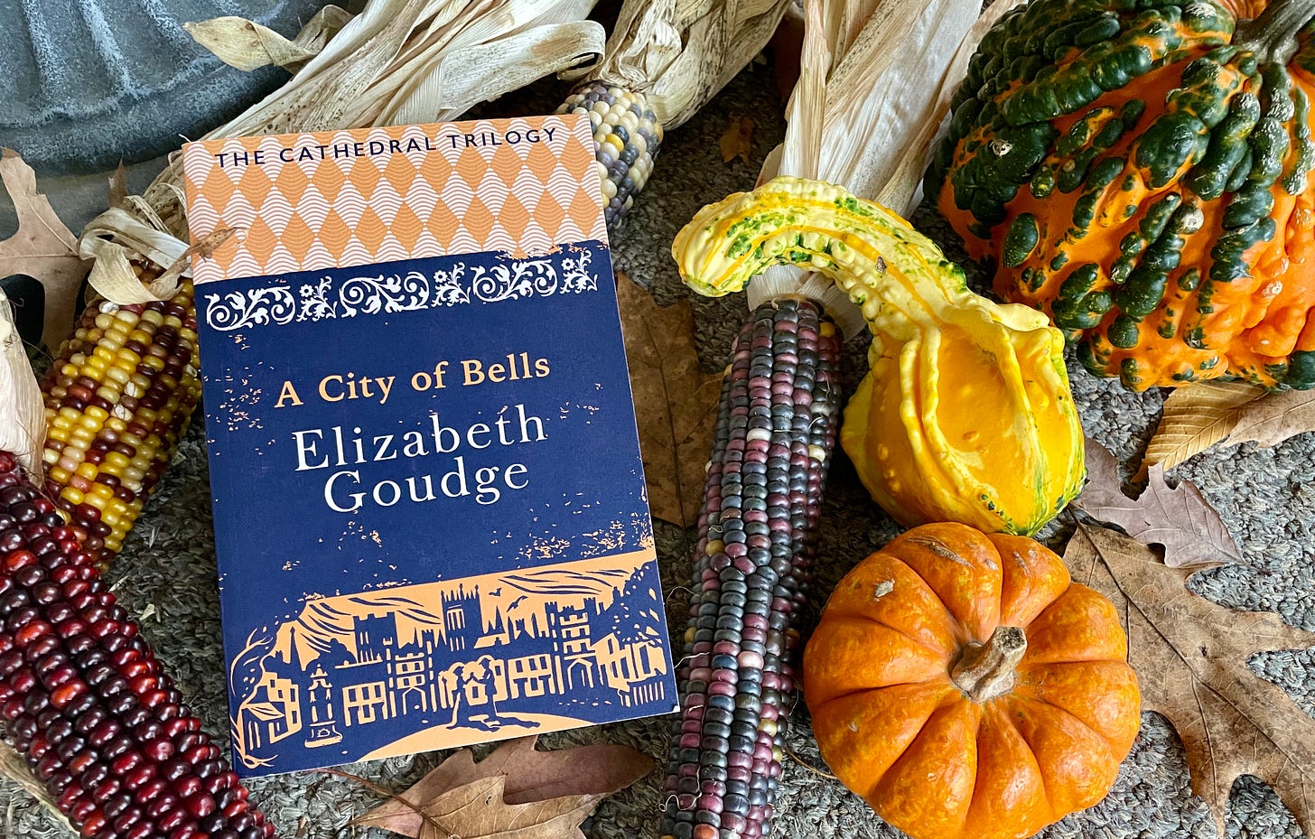 The cover of Hodder’s A City of Bells with my November gourds and corn