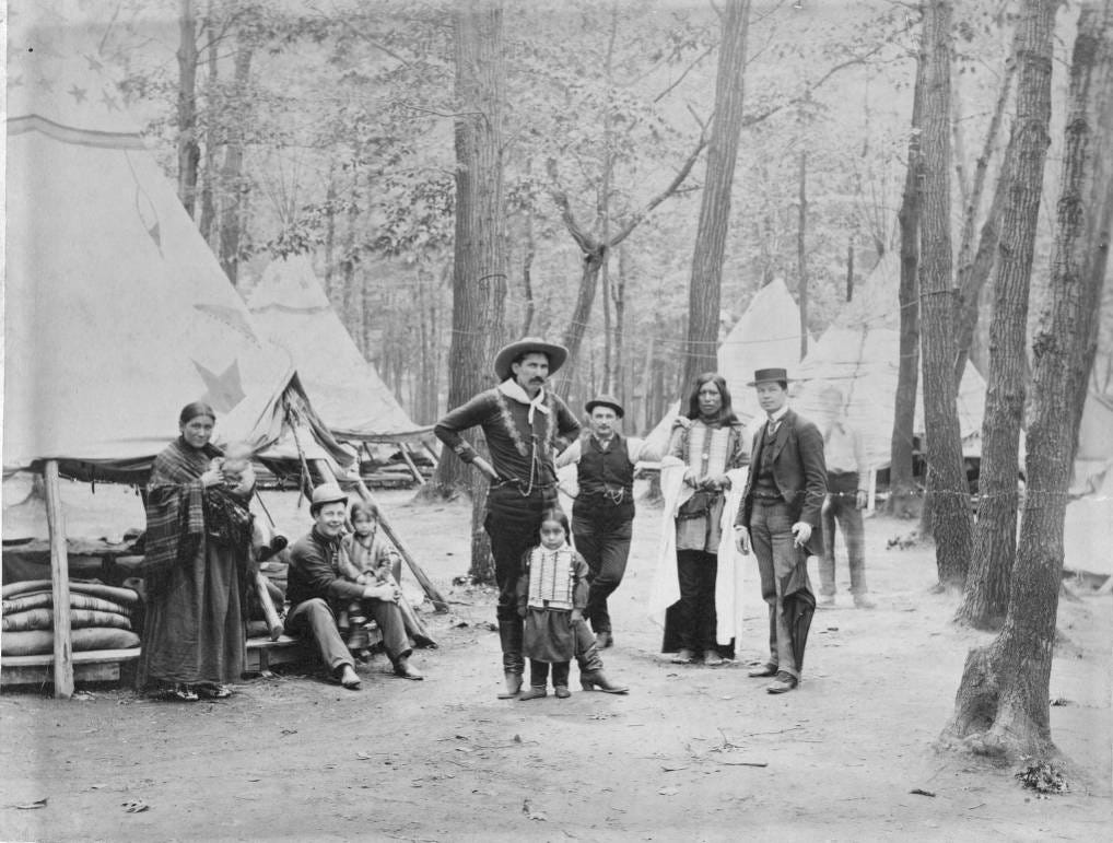Buck Taylor, men, women and children gathered near tipis
