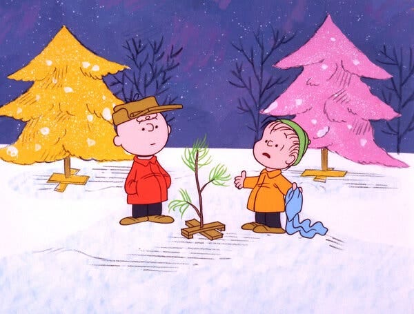 Two animated Peanuts characters, Charlie Brown and Linus, stand beside a very anemic Christmas tree in the snow.