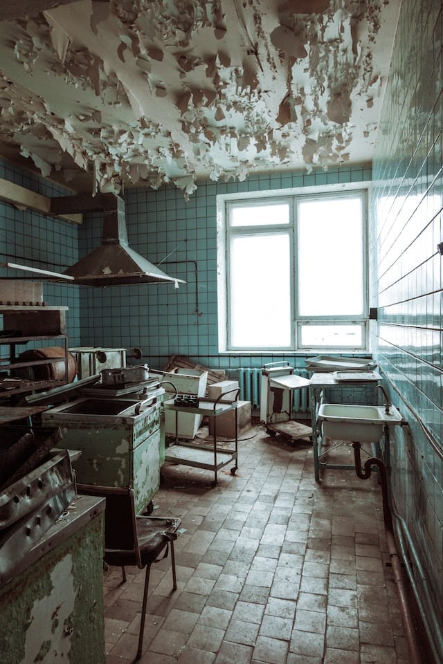 an abandoned industrial kitchen in a state of disrepair