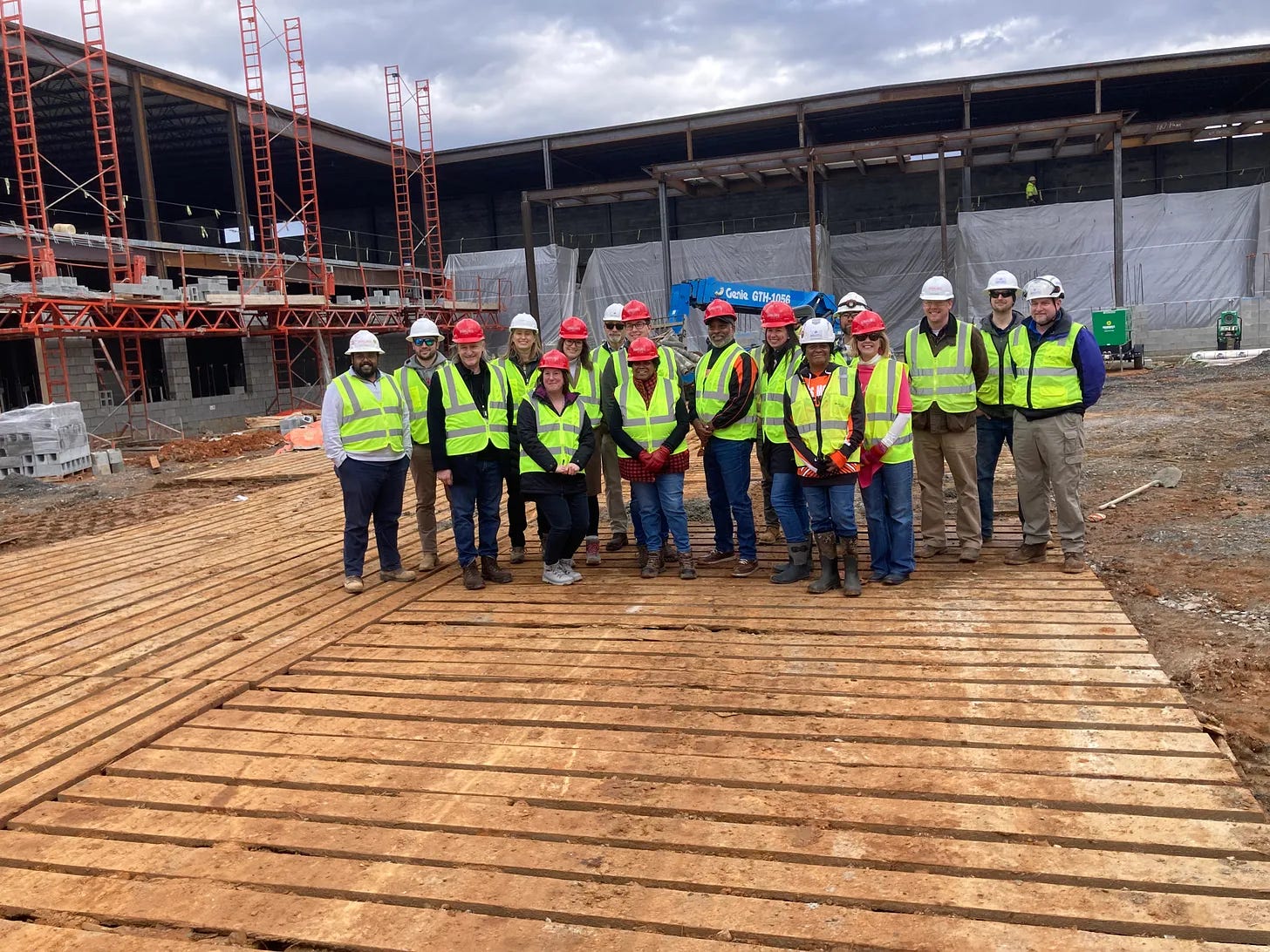 Fredericksburg School Board members, central office staff, and representatives from English Construction and Moseley Architects at the site of the new middle school in February 2024. Photo by Adele Uphaus. 
