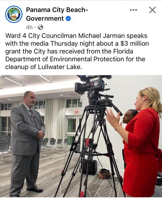 May be an image of 2 people, television and text that says 'ATNCITSIN FLORIDA Panama City Beach- Government 4h. Ward 4 City Councilman Michael Jarman speaks with the media Thursday night about a $3 million grant the City has received from the Florida Department of Environmental Protection for the cleanup of Lullwater Lake.'