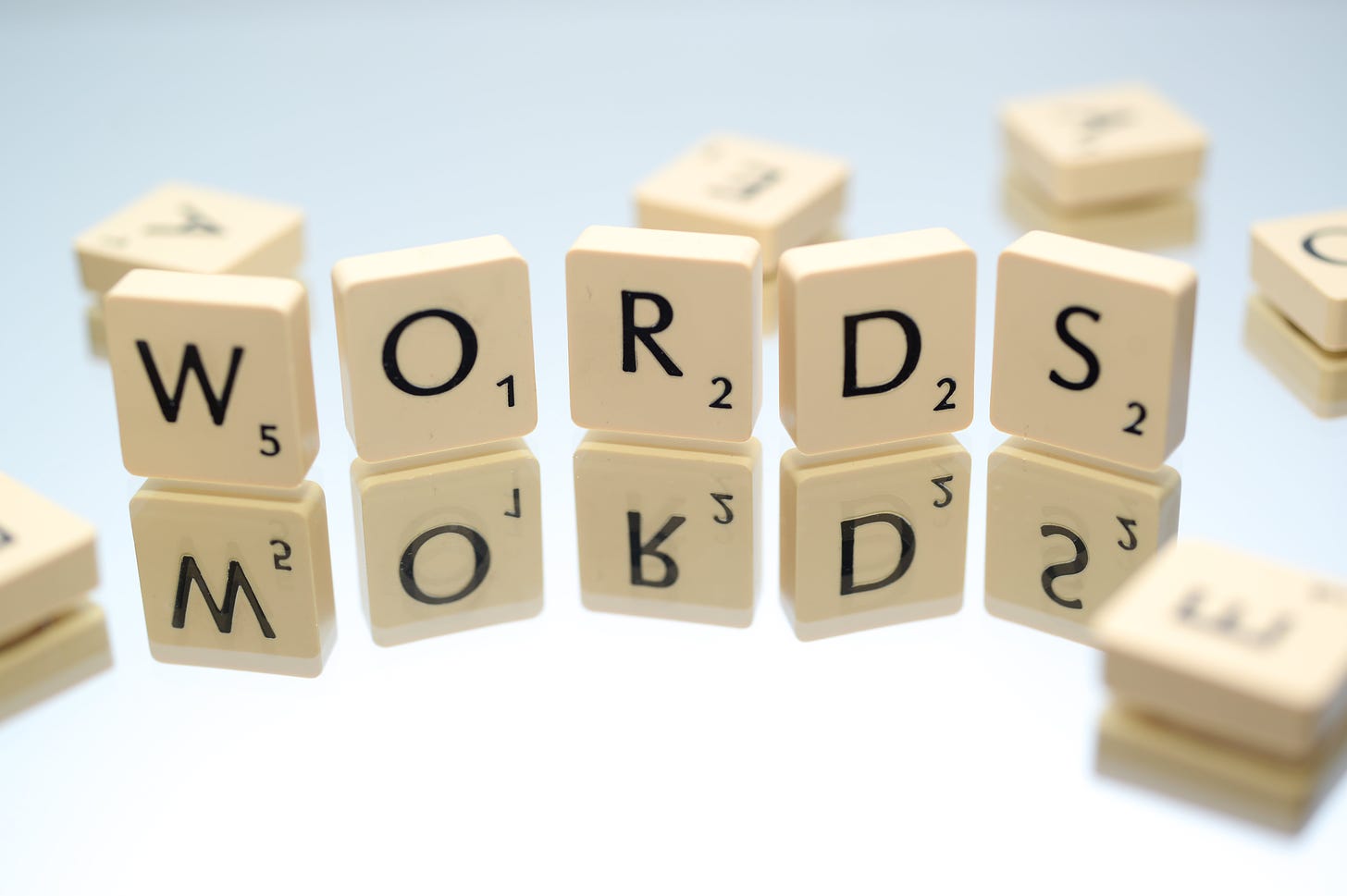 Scrabble pieces that build the word "words"
