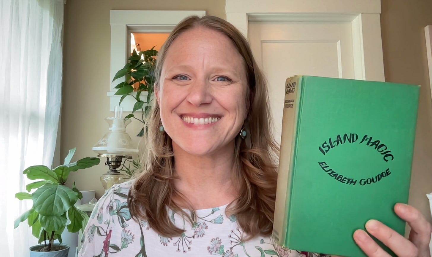 Book club leader Julie Witmer with her vintage copy of Island Magic by Elizabeth Goudge.