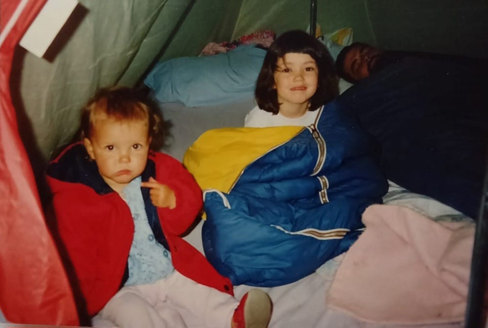 L-R My sister, me and Dad snoozing in the background. A shot of us waking up in the tent on a camping trip. I'm still in my bright blue and yellow sleeping bag (and have a terrible haircut because I'd recently cut my own fringe)