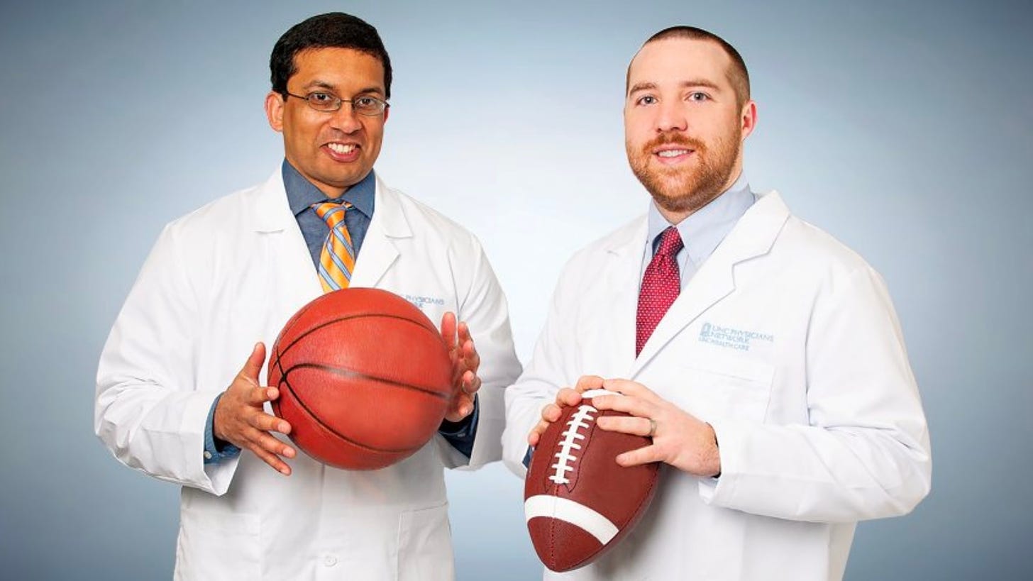 sports medicine doctors helping athlete
