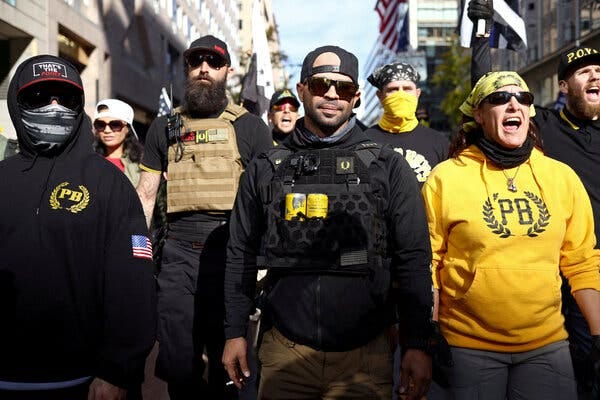 Enrique Tarrio and other members of the Proud Boys, wearing black and yellow, marching in Washington in November 2020.