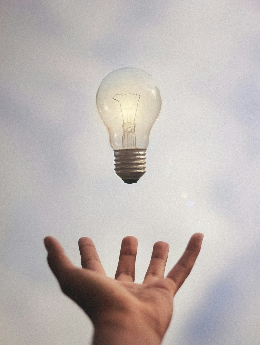 person catching light bulb person catching light bulb
