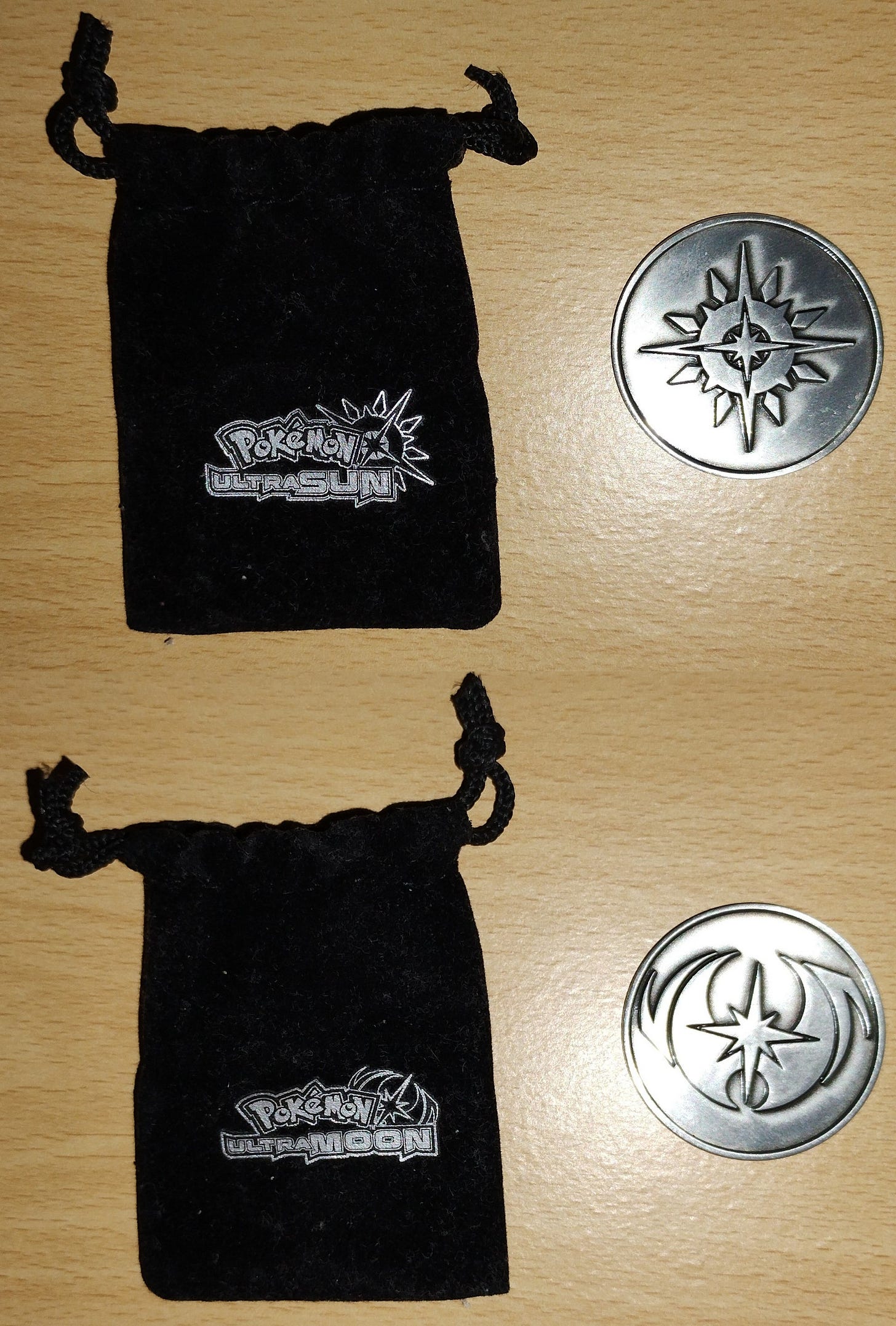 A double-sided Pokémon Ultra Sun & Ultra Moon pre-order bonus coin, which came in a double-sided pouch