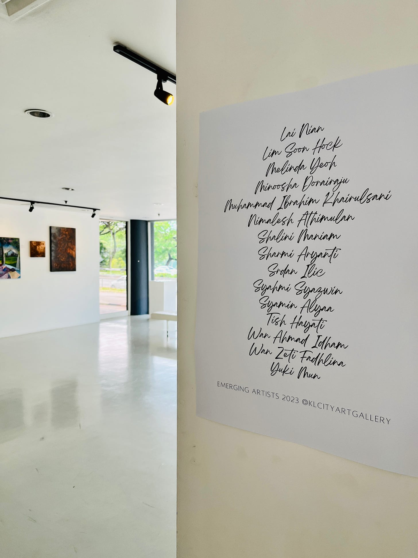 image: a list of the artists' name printed and displayed in the gallery.