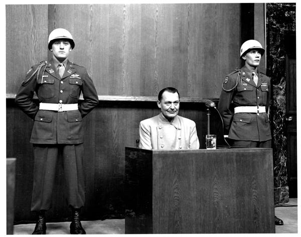 A group of men in military uniforms standing at a podium

Description automatically generated