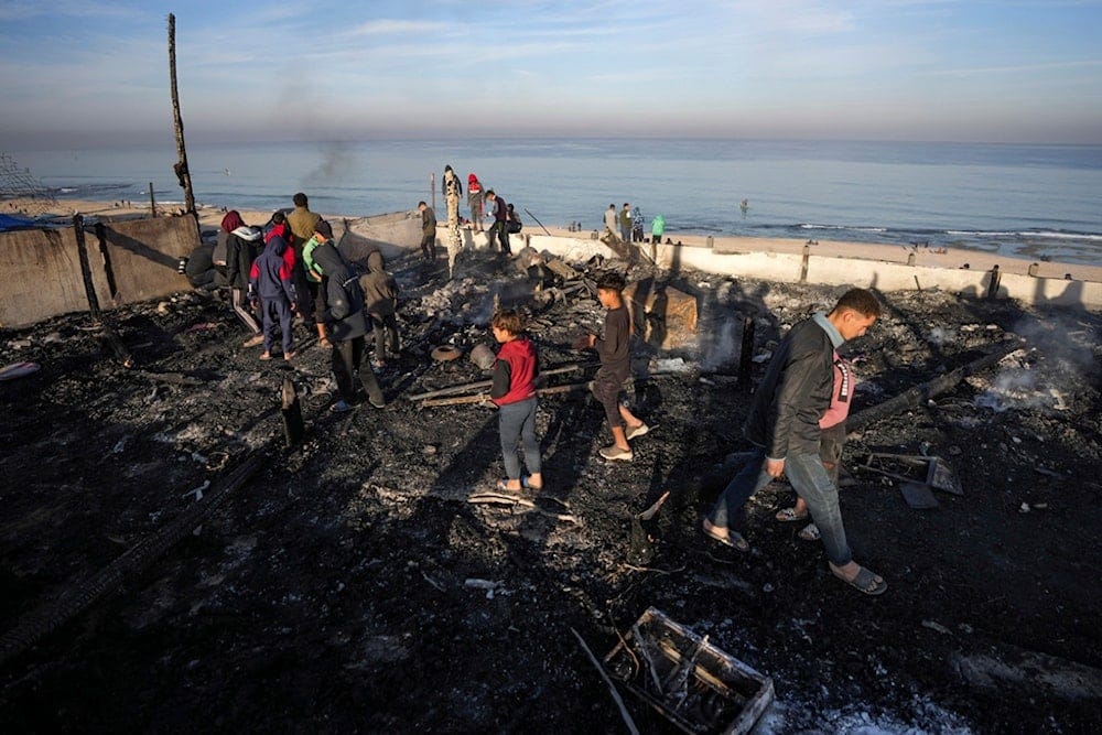 Palestinians inspect the site of an Israeli occupation forces strike early Tuesday morning in Deir al-Balah in the central Gaza Strip, Tuesday, January 14, 2025 (AP)