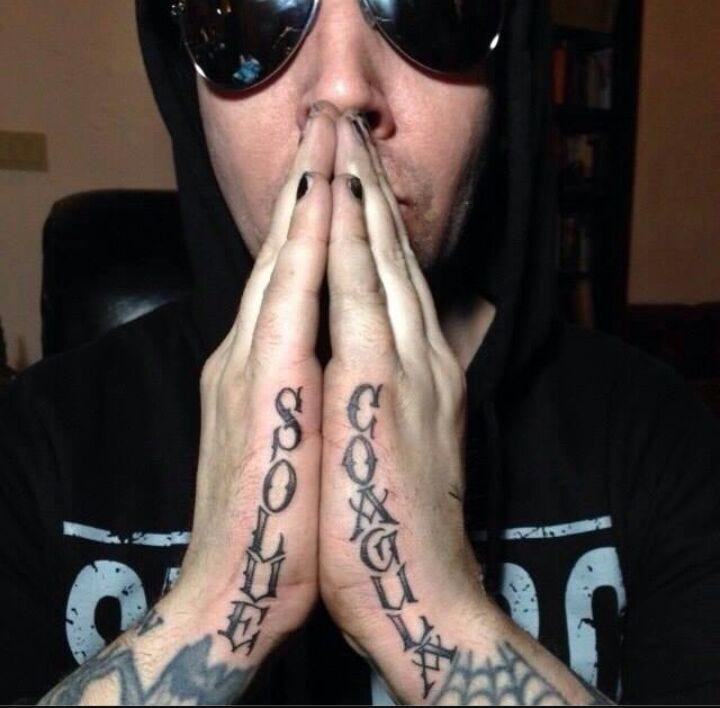 A person wearing sunglasses and a hoodie with his hands together

Description automatically generated