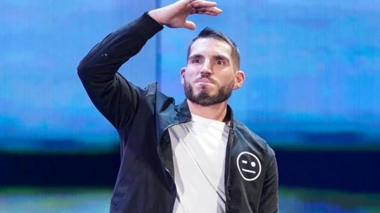 Johnny Gargano with his hand shielding his eyes