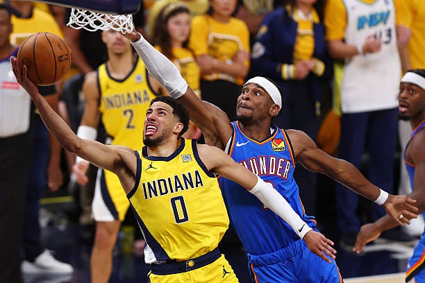 Tyrese Haliburton of the Indiana Pacers attempts a layup against Shai Gilgeous-Alexander of the Oklahoma City Thunder during the fourth quarter in...